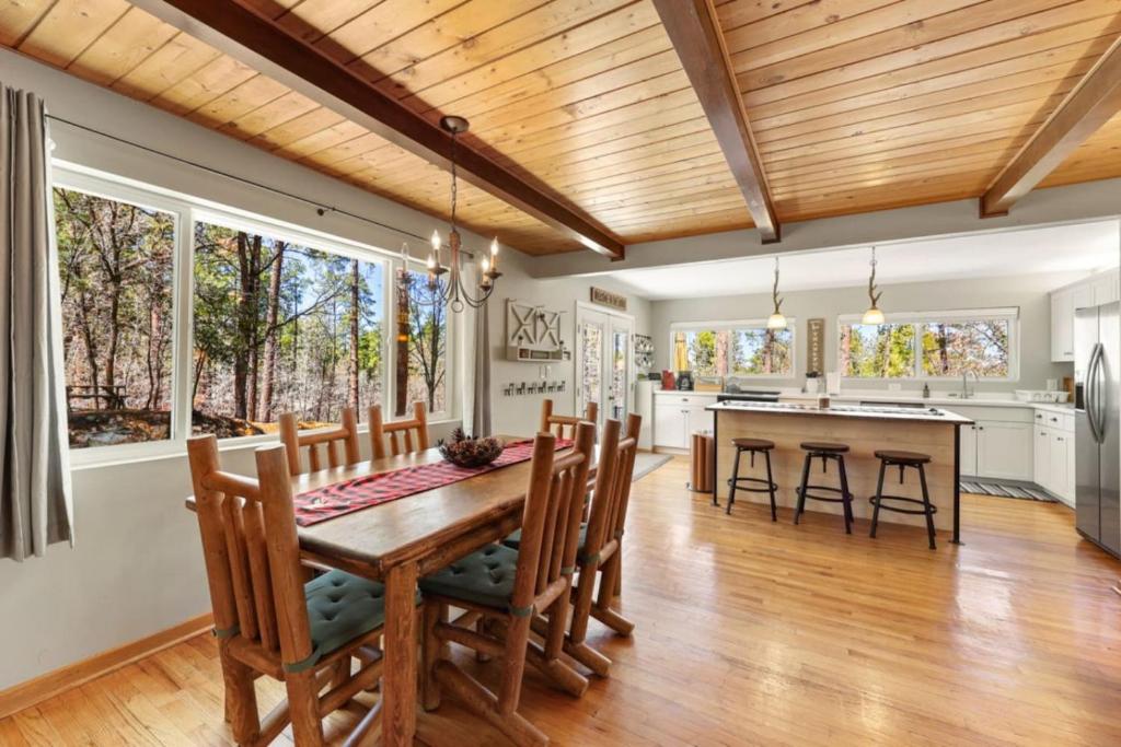 a kitchen and dining room with a wooden ceiling at Pine Cone Lodge Fire Pit BBQ Ping Pong in Prescott
