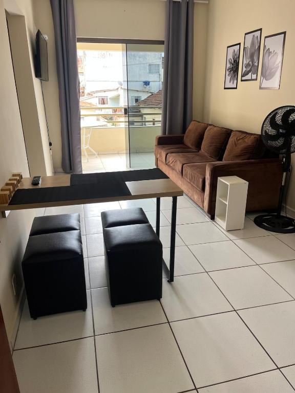 a living room with a couch and a table at Apartamento Central em Alfenas in Alfenas