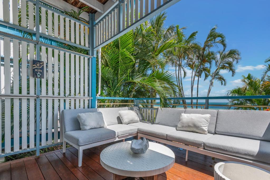 a living room with a couch and a table at Tangalooma Beachfront Villa 23 2 bedroom in Tangalooma
