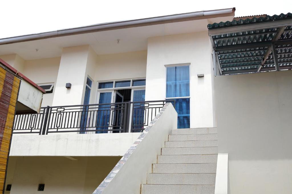 a staircase leading up to a building with windows at Bungo Bed & Breakfast Workation in Bukittinggi