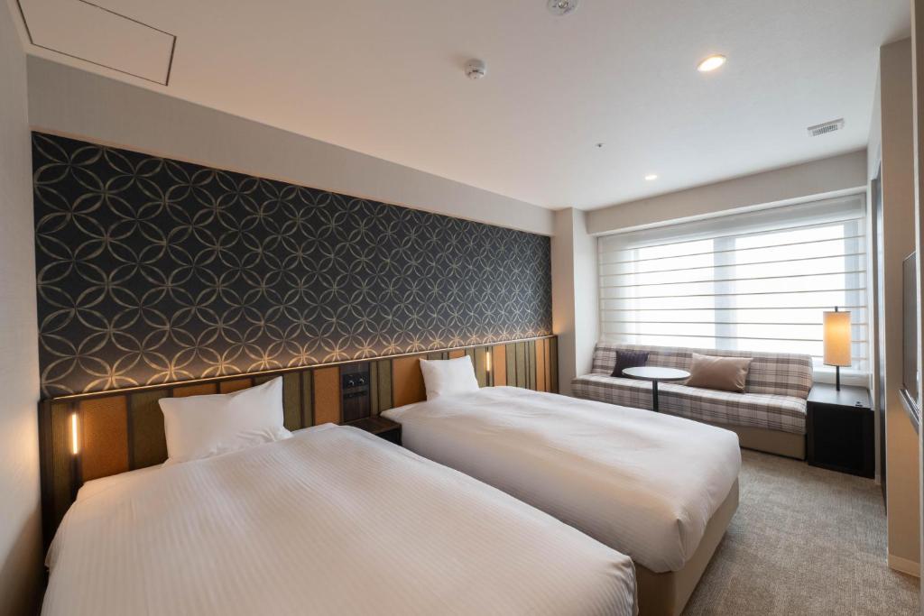 Postel nebo postele na pokoji v ubytování Loisir Hotel Kyoto Toji