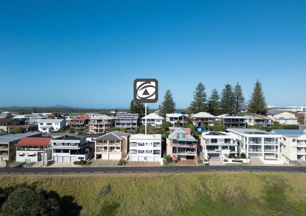 arial view of a city with a sign and houses at Avalon 4 in Yamba
