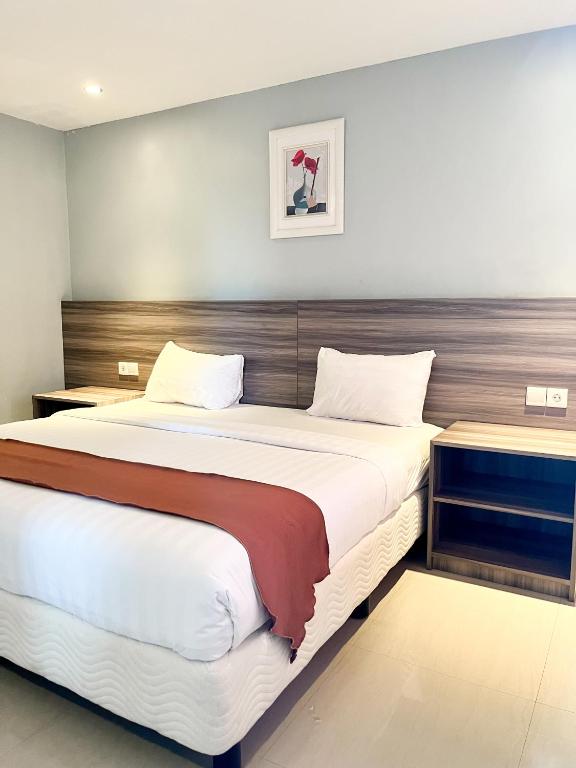 Postel nebo postele na pokoji v ubytování SM Tower Hotel and Convention Berau