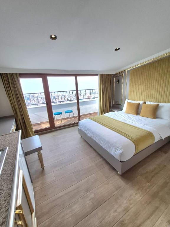 a bedroom with a large bed and a large window at Taksim La Marino Hotel in Istanbul