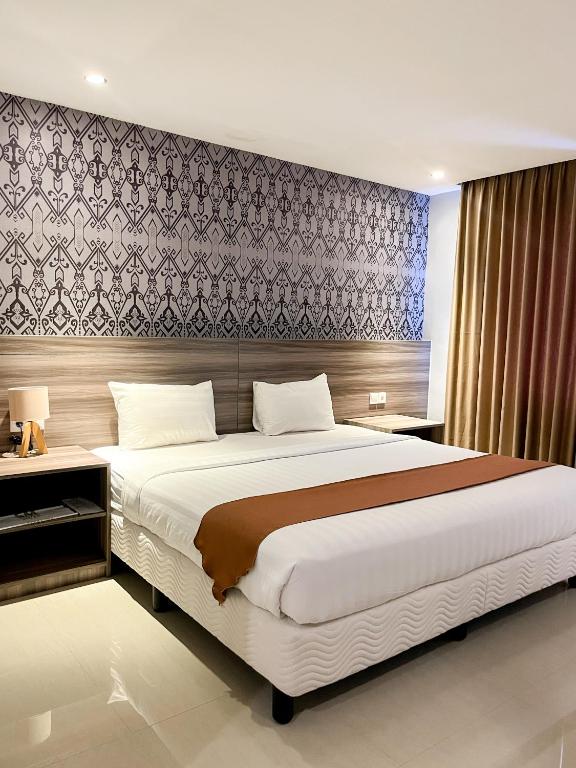 Postel nebo postele na pokoji v ubytování SM Tower Hotel and Convention Berau