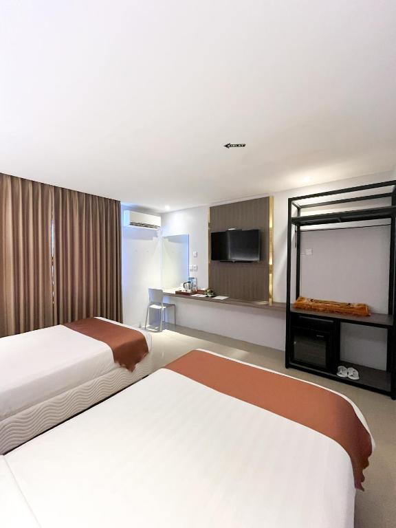 Postel nebo postele na pokoji v ubytování SM Tower Hotel and Convention Berau