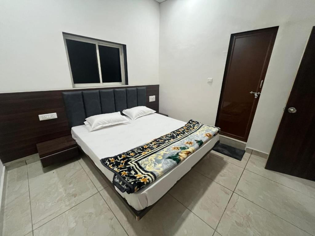a large bed in a room with at Hotel Mewad Palace in Chharodi