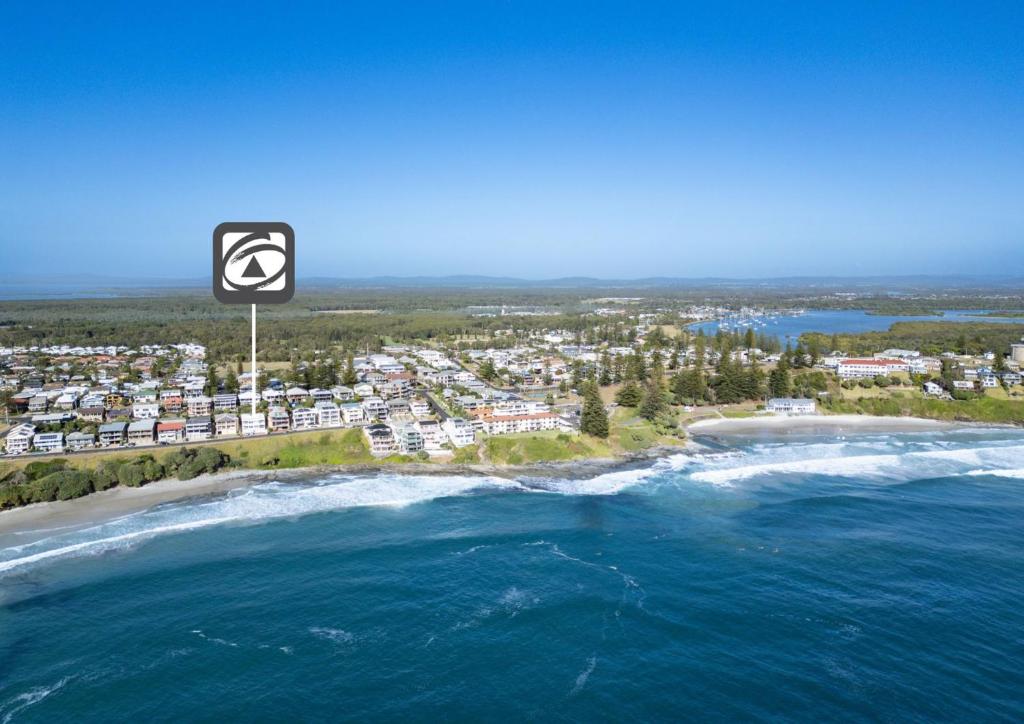 an aerial view of a beach with a speed limit sign at Avalon 4 in Yamba