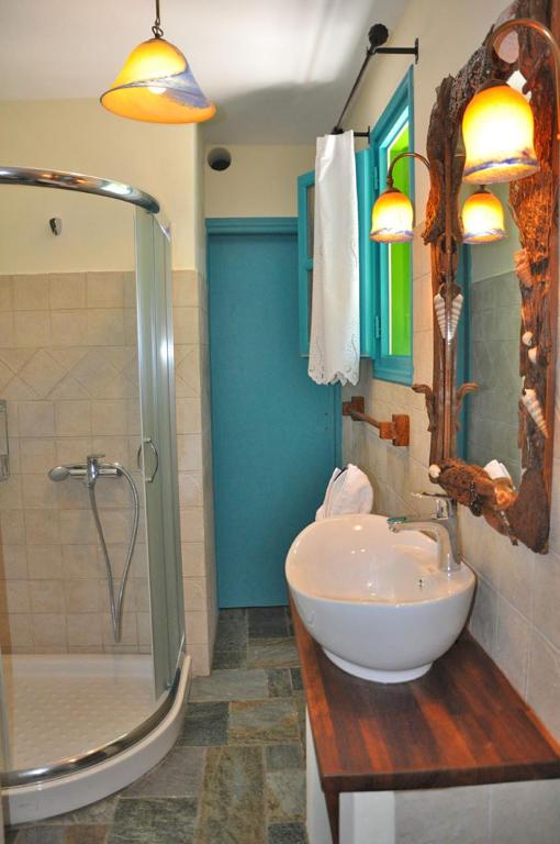 a bathroom with a sink and a shower at Pano Gitonia in Aegiali