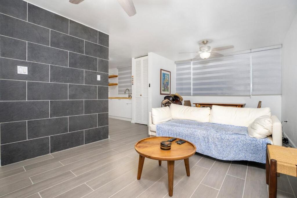 a living room with a couch and a table at 3 Story Penthouse with Ocean Views in Vega Alta
