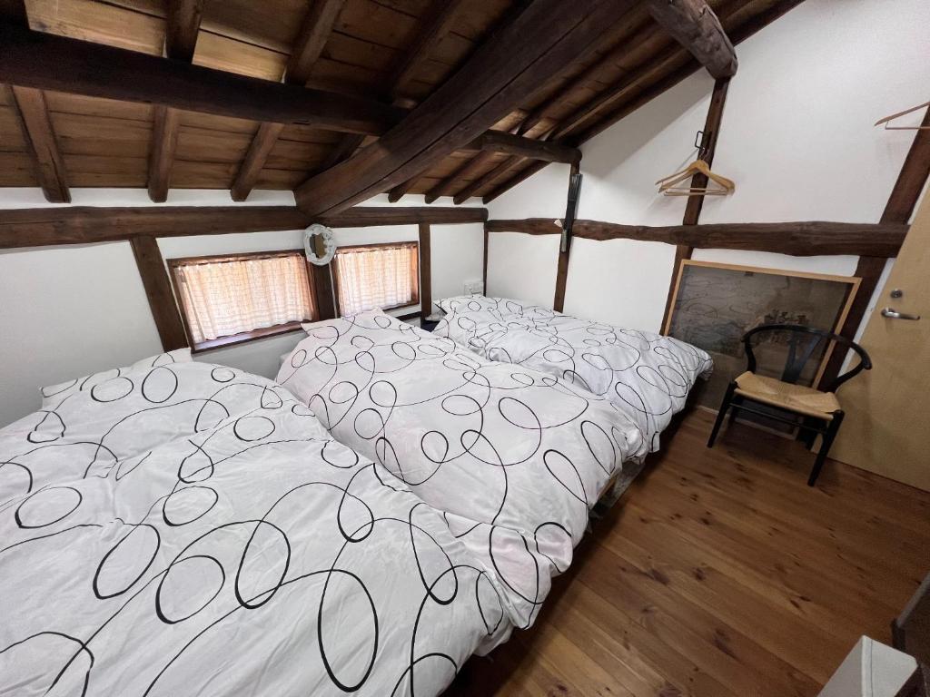 a large bed in a room with a wooden floor at Hillshouse2 - Vacation STAY 67982v in Tokoname
