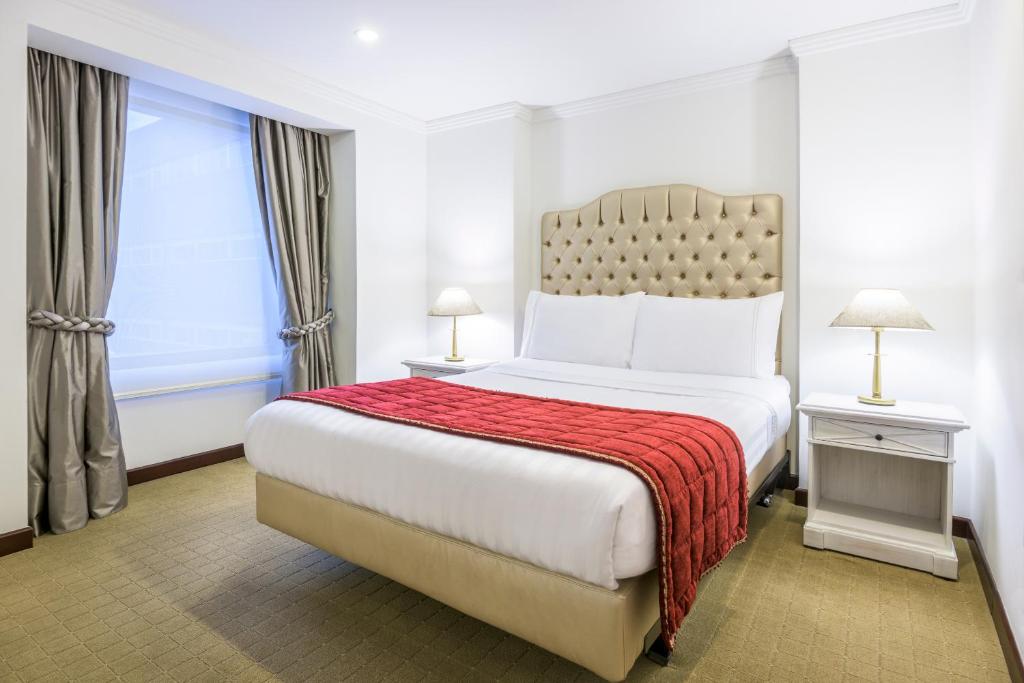 Postel nebo postele na pokoji v ubytování GHL Hotel Hamilton