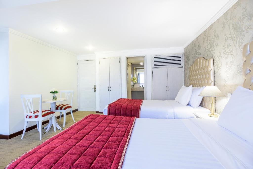 Postel nebo postele na pokoji v ubytování GHL Hotel Hamilton