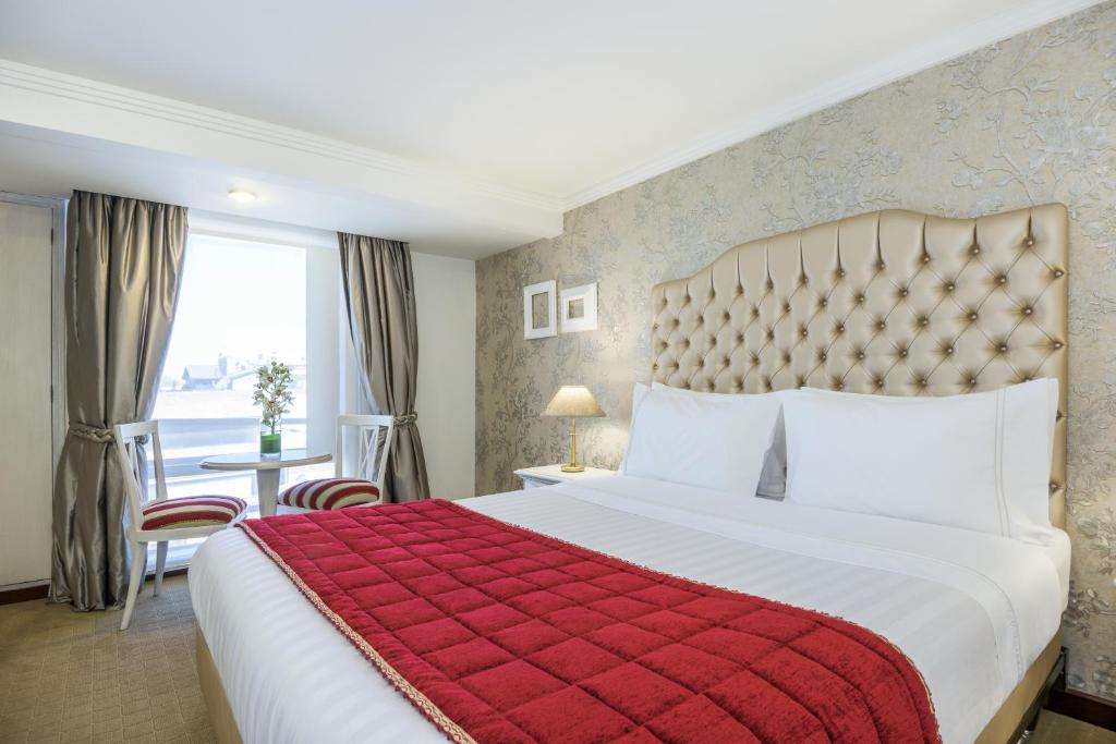 Postel nebo postele na pokoji v ubytování GHL Hotel Hamilton