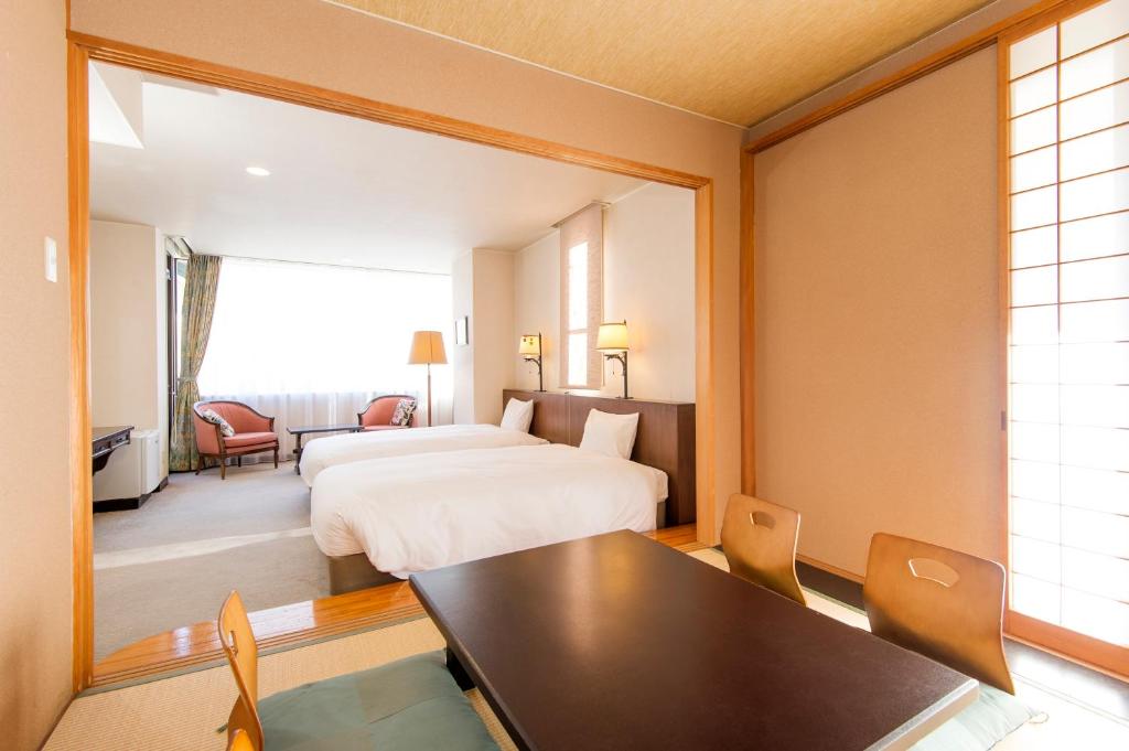 Postel nebo postele na pokoji v ubytování Hakuba Mominoki Hotel