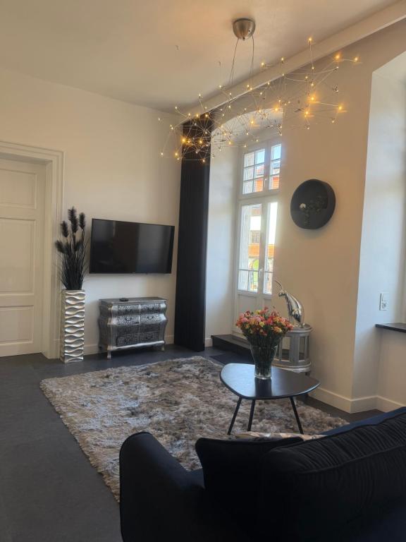 a living room with a couch and a table at I'M Apartment PLATINUM premium in Bolesławiec