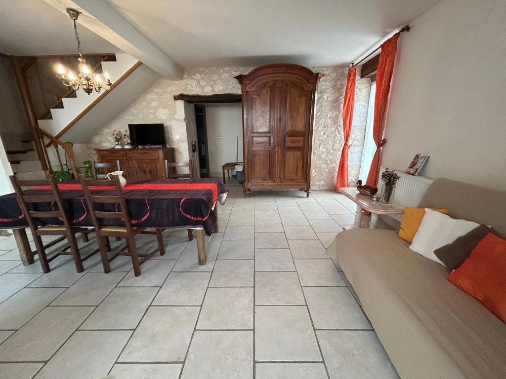 un salon avec une table et un canapé dans l'établissement Holiday cosy house, à Eymet
