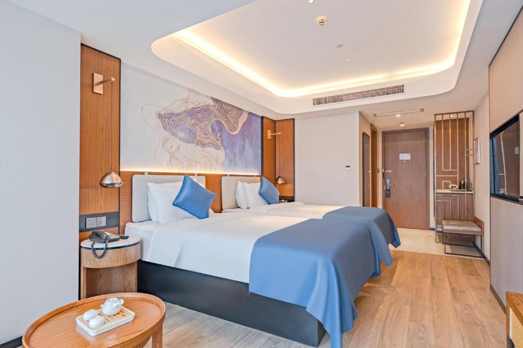 Postel nebo postele na pokoji v ubytování Yunfei Hotel - Shanghai Hongqiao Wuzhong Road Branch