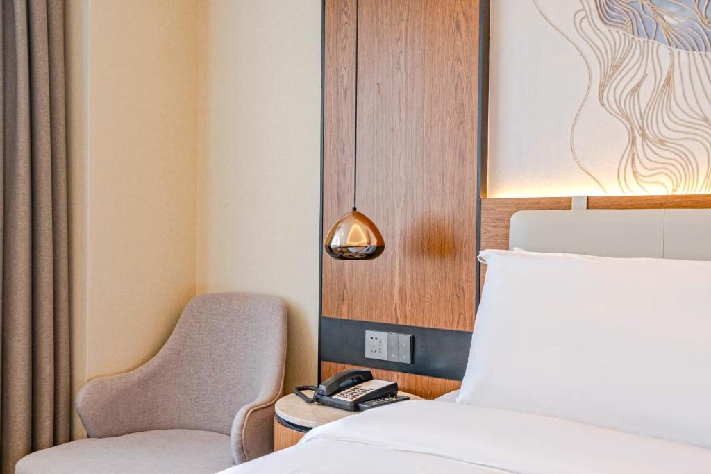 Postel nebo postele na pokoji v ubytování Yunfei Hotel - Shanghai Hongqiao Wuzhong Road Branch