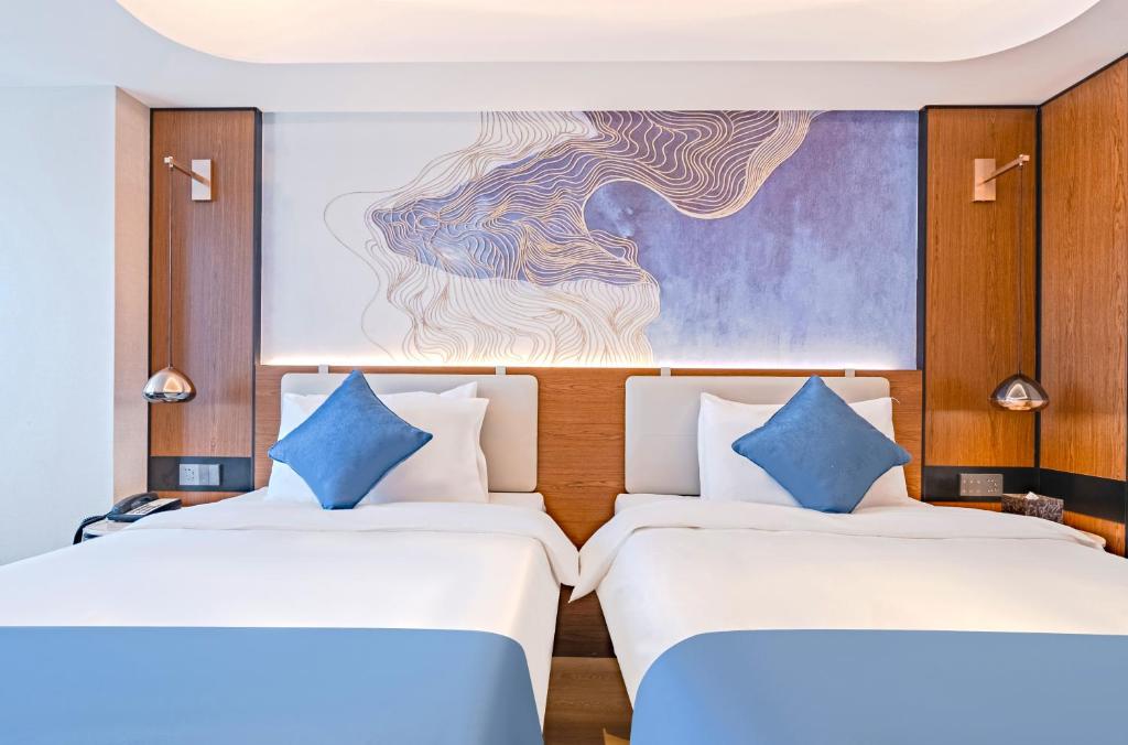 Postel nebo postele na pokoji v ubytování Yunfei Hotel - Shanghai Hongqiao Wuzhong Road Branch