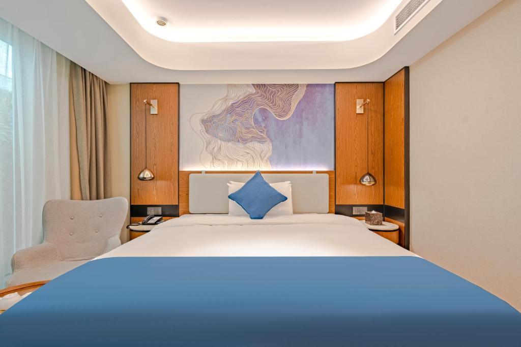 Postel nebo postele na pokoji v ubytování Yunfei Hotel - Shanghai Hongqiao Wuzhong Road Branch