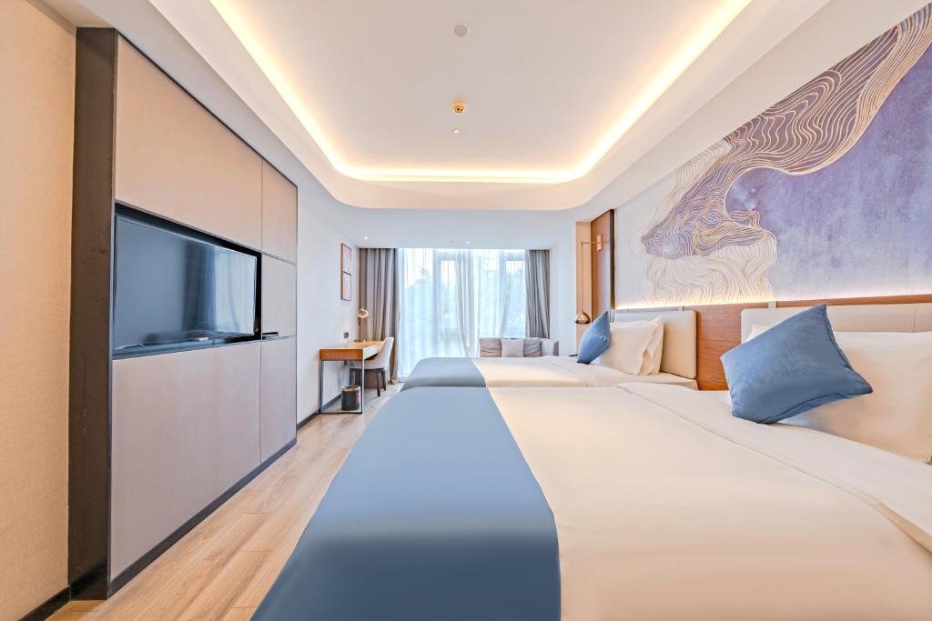 Postel nebo postele na pokoji v ubytování Yunfei Hotel - Shanghai Hongqiao Wuzhong Road Branch