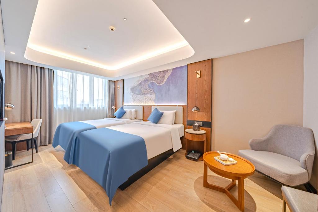 Postel nebo postele na pokoji v ubytování Yunfei Hotel - Shanghai Hongqiao Wuzhong Road Branch