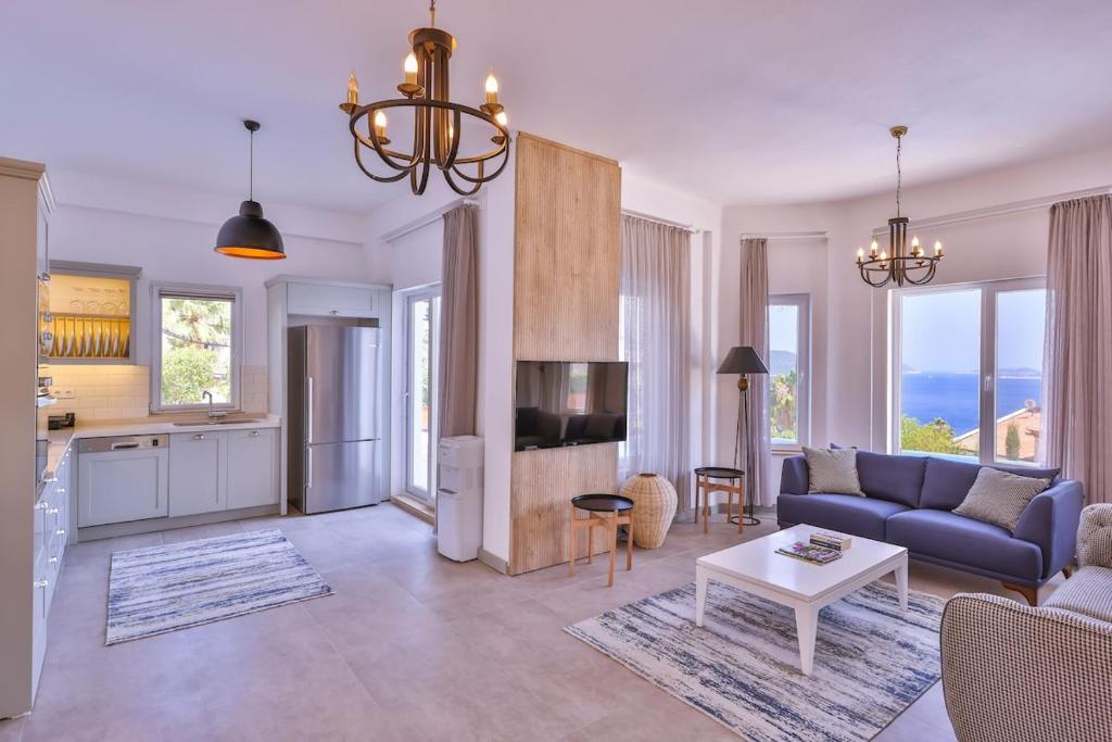 a living room with a blue couch and a table at Villa Melissa Kaş Peninsula in Kaş
