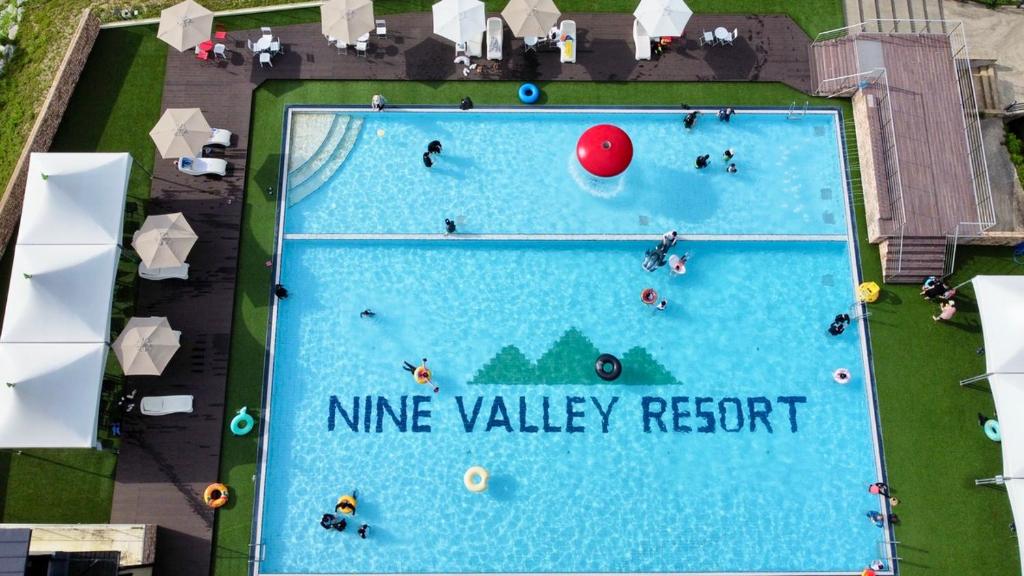an overhead view of a swimming pool with people playing at Nine Valley Park in Boeun