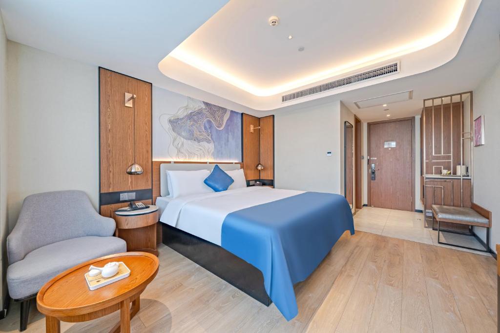 Postel nebo postele na pokoji v ubytování Yunfei Hotel - Shanghai Hongqiao Wuzhong Road Branch