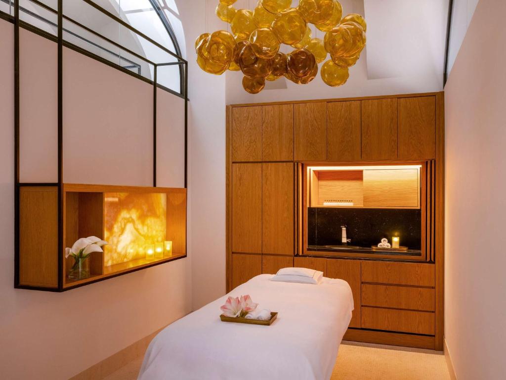 a bedroom with a bed and a fireplace at Raffles Europejski Warsaw in Warsaw