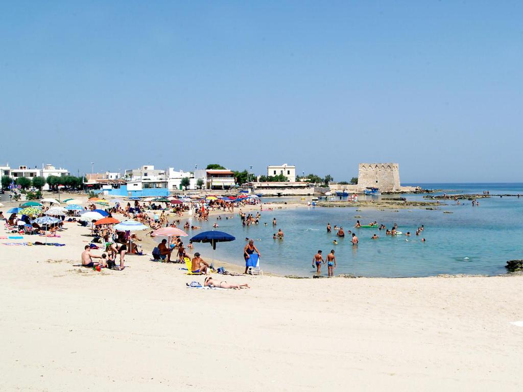 a group of people on a beach in the water at Al Ristoro in Torre Santa Sabina