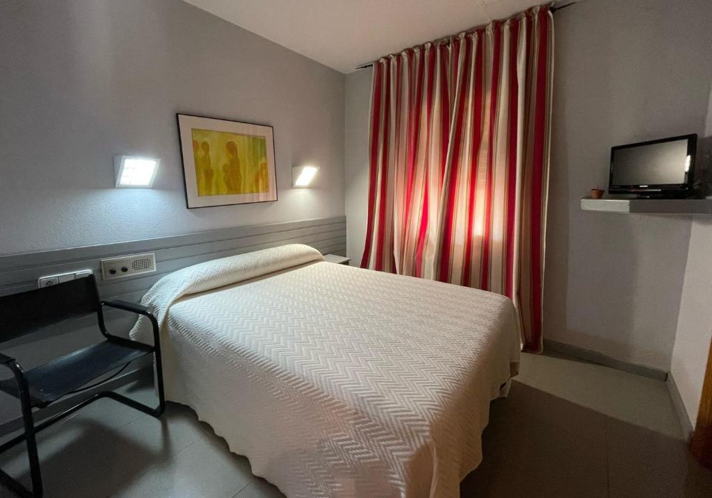 Postel nebo postele na pokoji v ubytování Hotel Fidalgo