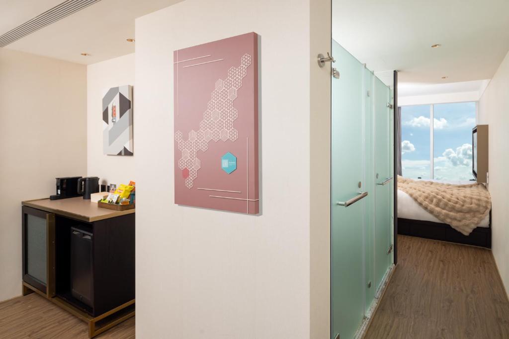 Postel nebo postele na pokoji v ubytování Voyage Kaohsiung By Cosmos Oasis