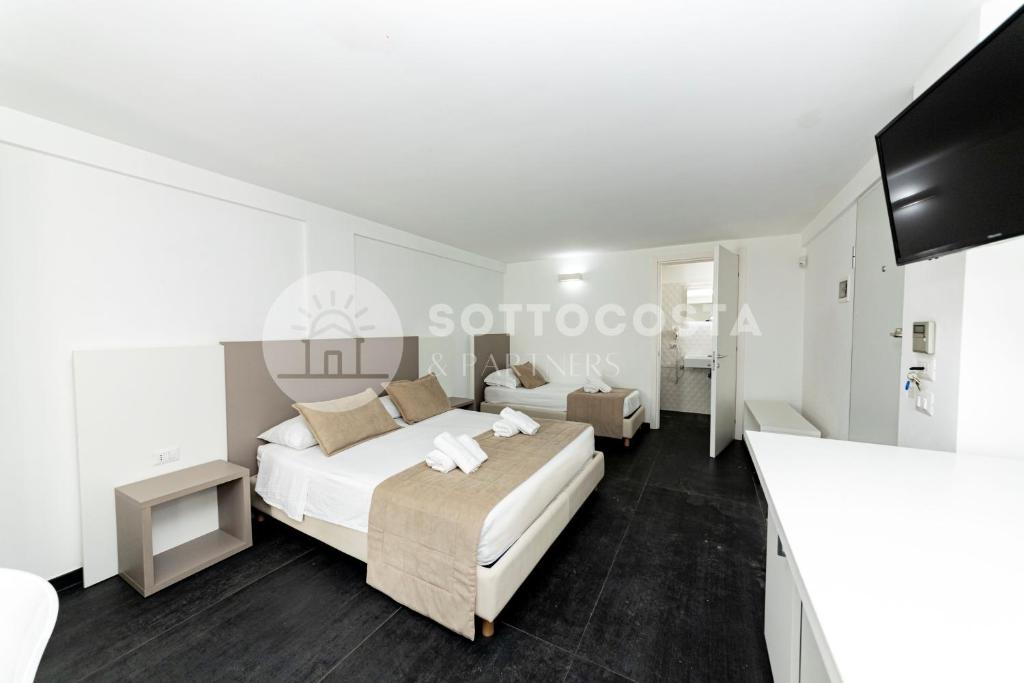 Łóżko lub łóżka w pokoju w obiekcie Ungaretti Resort
