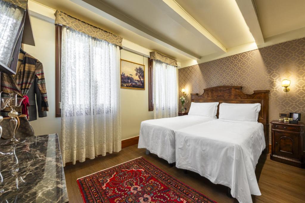 Postel nebo postele na pokoji v ubytování Hotel Casa Nicolò Priuli