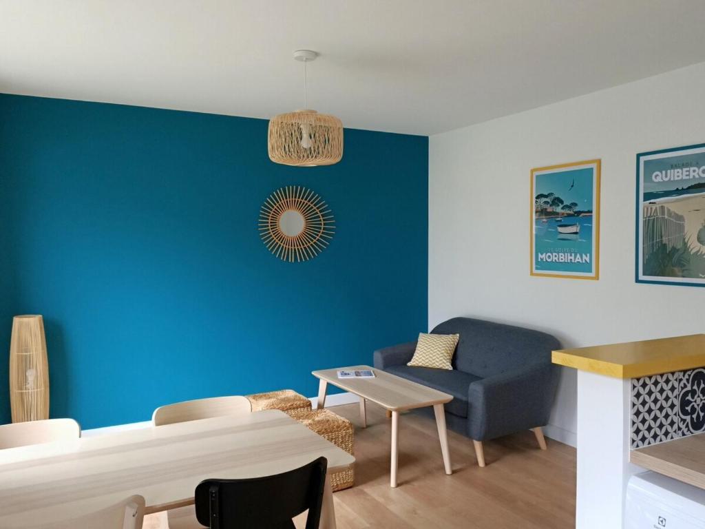 un salon avec un mur d'accent bleu dans l'établissement Saint-Patern - centre-ville - Wifi, à Vannes