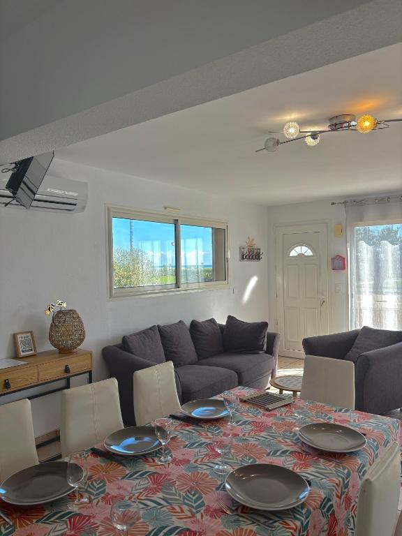 un salon avec une table et un canapé dans l'établissement Appartement 7 personnes face mer 7BLION37, au Barcarès
