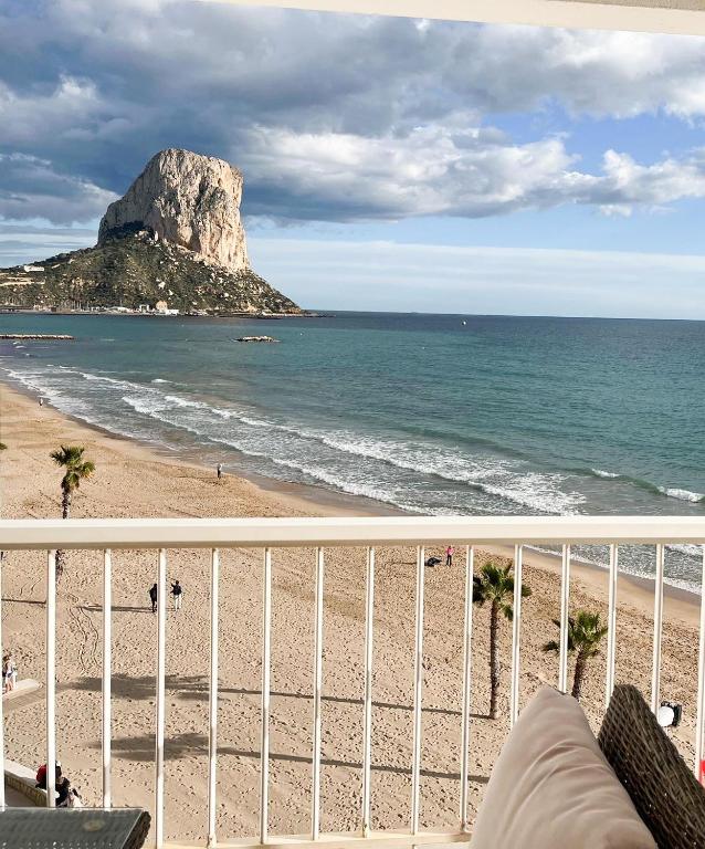 a view of a beach with a rock in the ocean at Europa II in Calpe