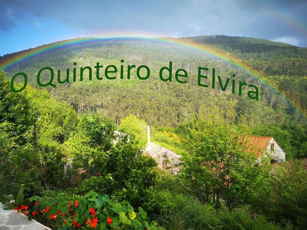 a rainbow over a mountain with the words noura de eminem at O Quinteiro de Elvira in Moaña
