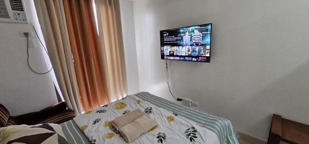 a hospital room with a bed and a tv on the wall at Homey822 in Davao City