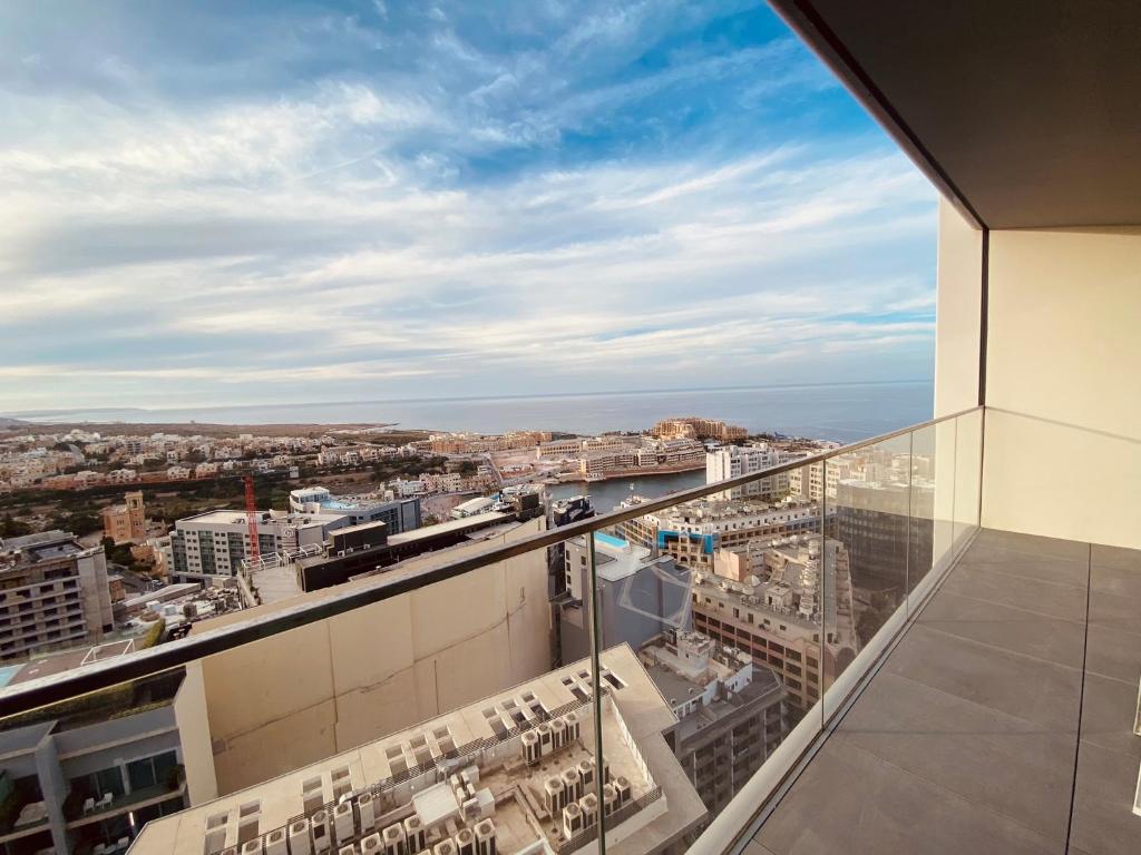 a view of the city from a building at Sea view Mercury Tower, Rooftop infinity Pool in St. Julianʼs