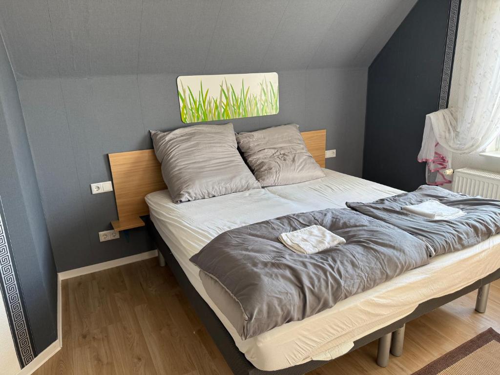a bed with two pillows on it in a bedroom at Apartments in Garbsen in Garbsen