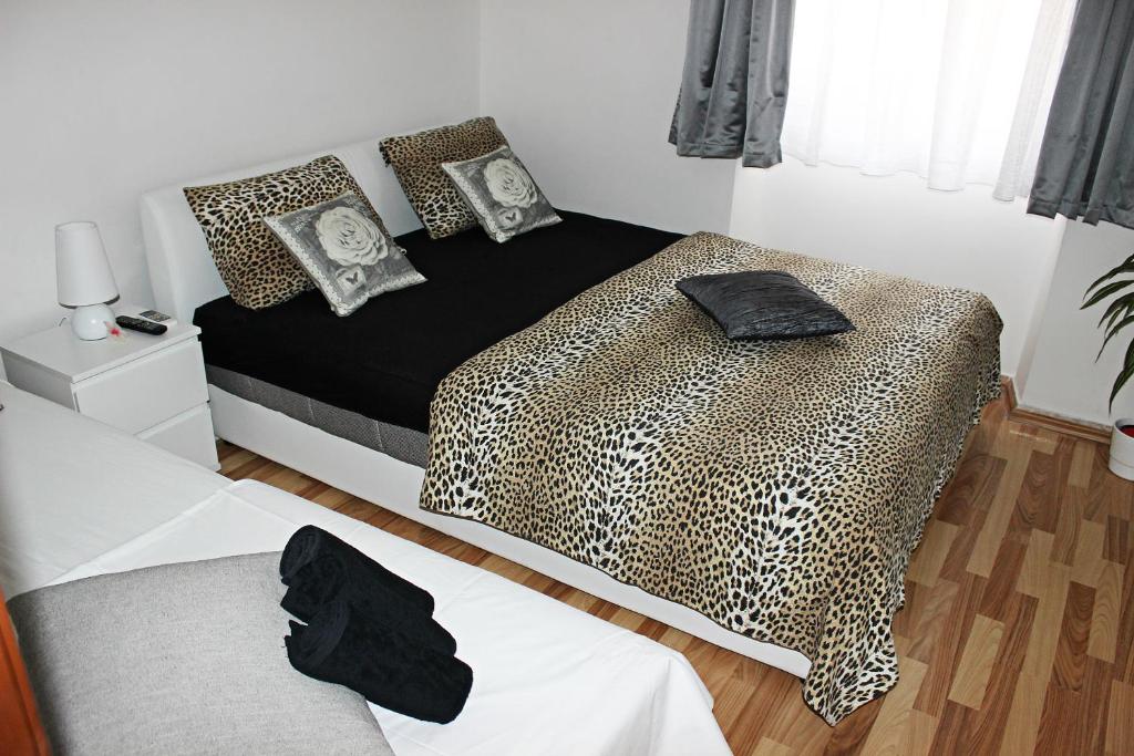 a bedroom with a bed with a leopard print at Room near the center in Split