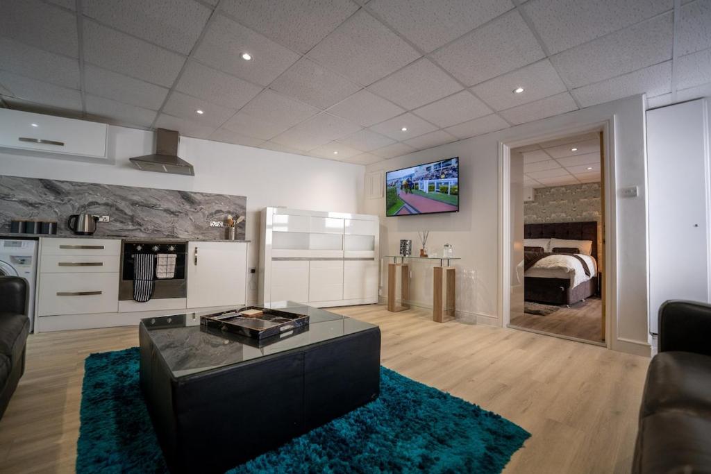 a living room with a couch and a tv on the wall at Luxury 1bed - Contractors Welcome - Fast WiFi in Cleethorpes