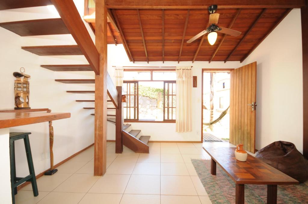 ein Wohnzimmer mit einer Treppe und einer Holzdecke in der Unterkunft Buzios Casa 1 in Búzios