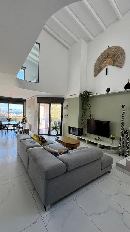 a large living room with a couch and a tv at Sea View Luxury Ap Solistice in Chania Town