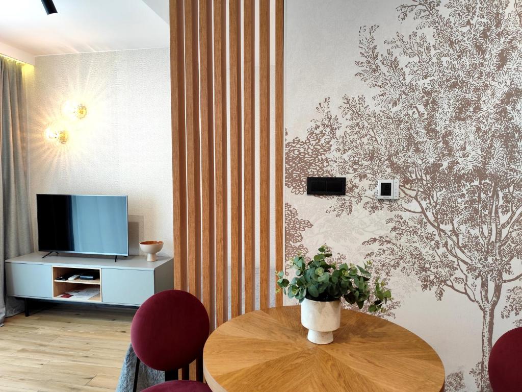 Televízia a/alebo spoločenská miestnosť v ubytovaní Easy Rent Apartments - Unia Art Residence 83
