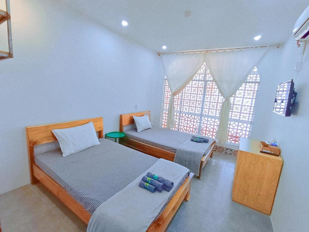 Postel nebo postele na pokoji v ubytování MEKONG HUB Hotel