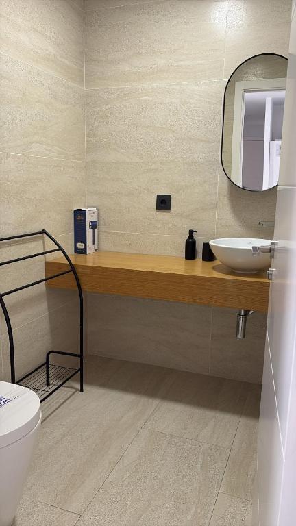 a bathroom with a sink and a mirror at LHOME CÁDIZ in Cádiz